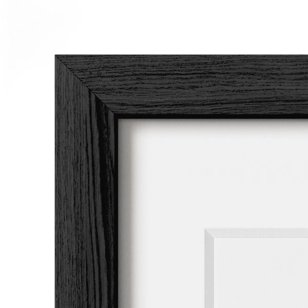 Corner of a black oak frame with a white mat